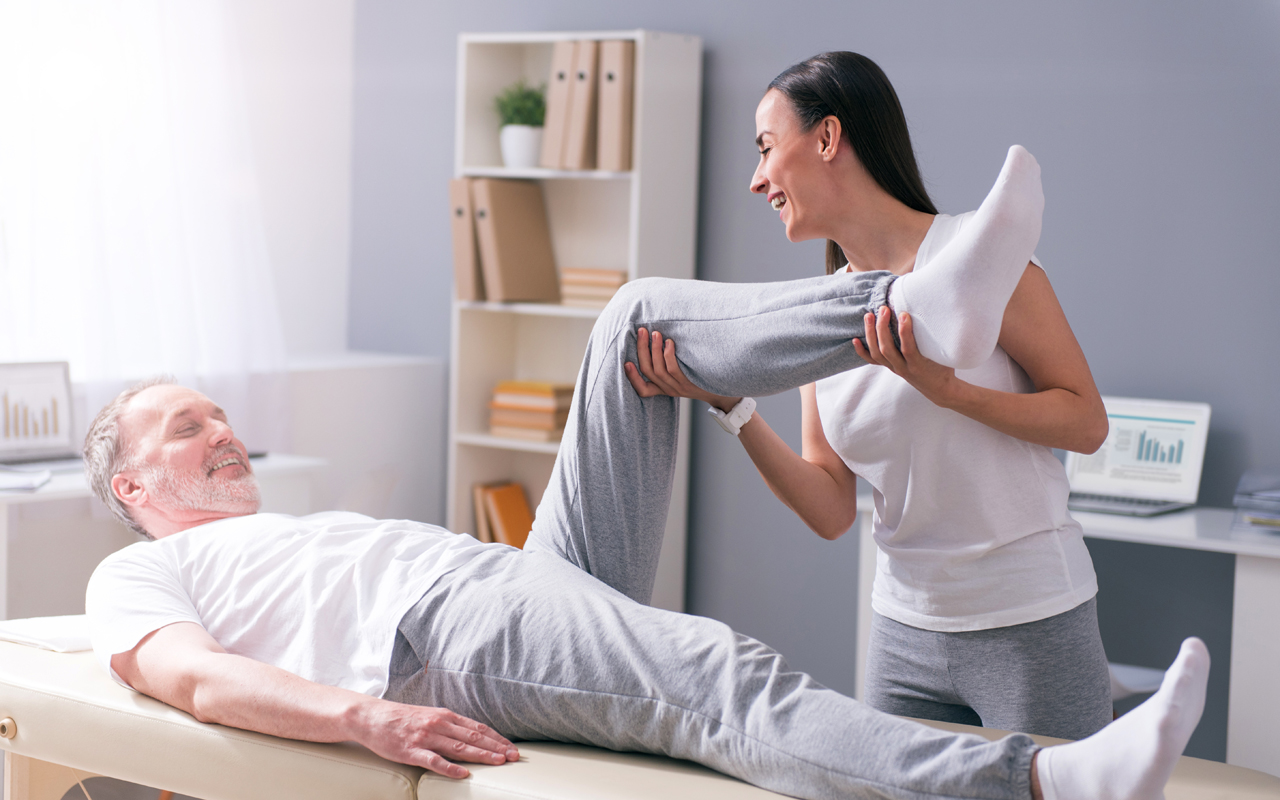 Eine Physiotherapeutin behandelt einen Patienten