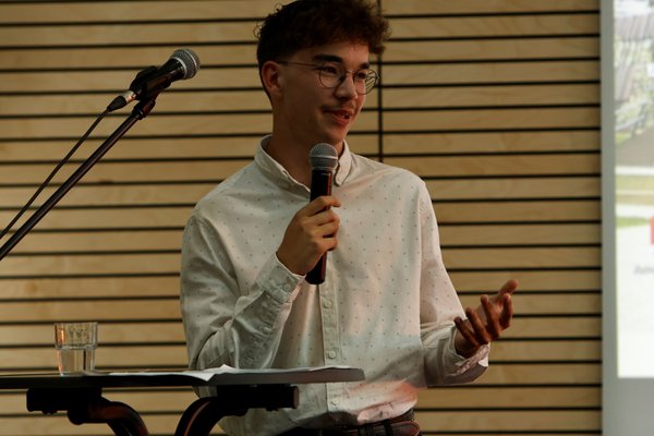 Der ehemalige Schüler des Landschulheim Elkofen, Lukas, spricht in ein Mikrofon