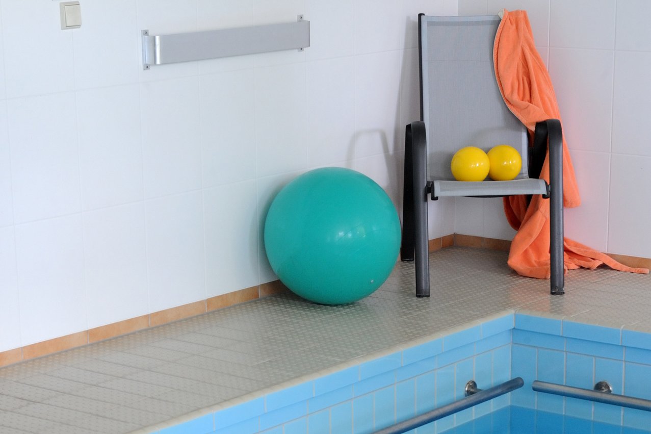 Gymnastikbälle am Rand eines Schwimmbeckens